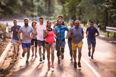 Full length of marathon runners having a race through nature