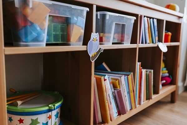 bookshelf with books and toys at daycare