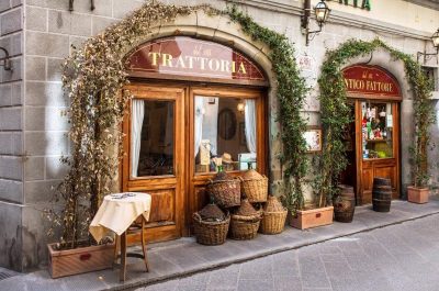 view of trattoria door with baskets piled beside it