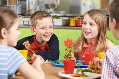 Kids eating lunch around a table