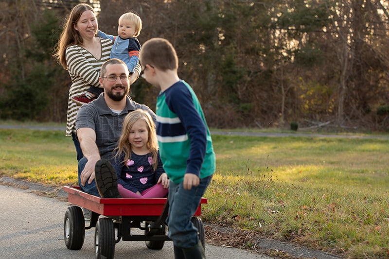 PKU Elizabeth and family walking and pulling a wagon