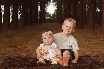 Aspen and Finn seated on the ground